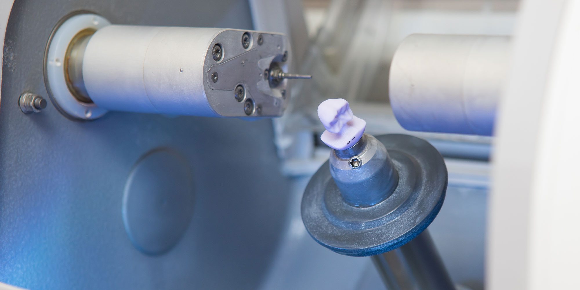 Close up of CEREC machine procuring porcelain crowns