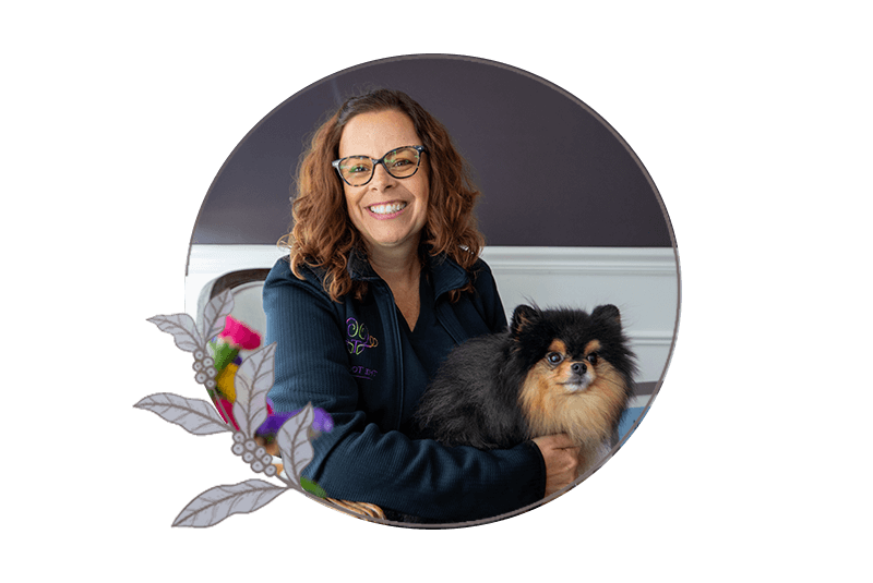 Invisalign patient smiling brightly while hanging out with dental center canine companion