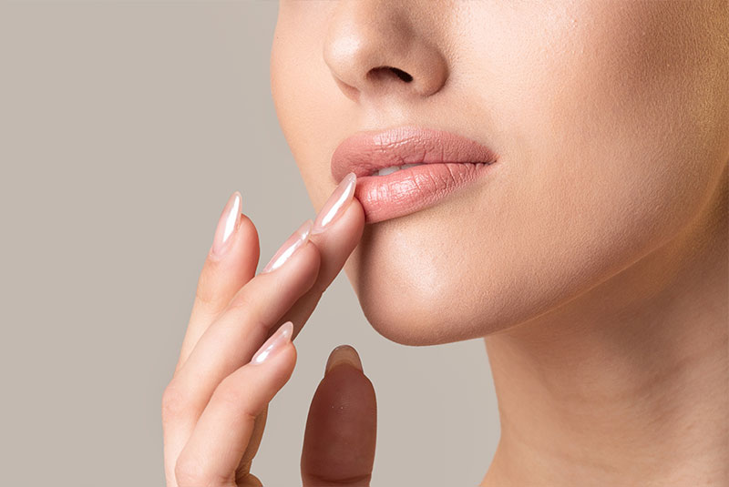 close up of dermal filler patient feeling their lips