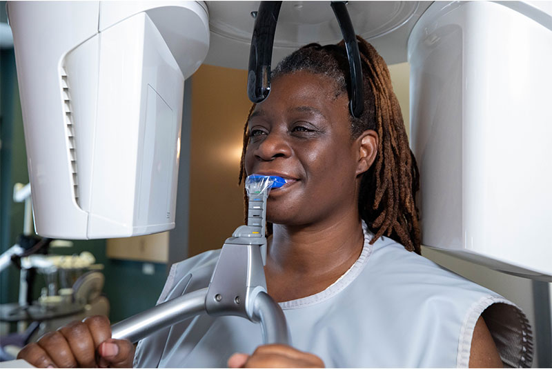 patient undergoing a CBCT scan for their dental procedure