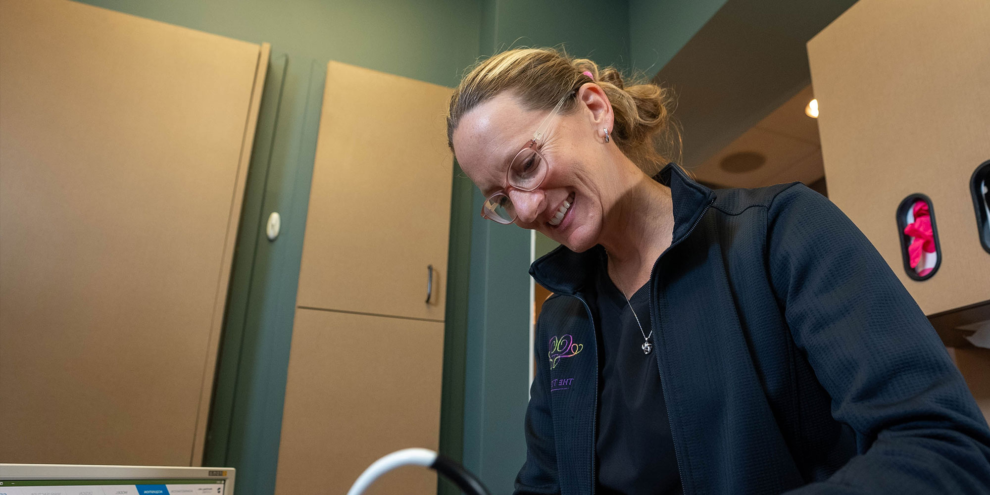staff member examining patient within the dental practice