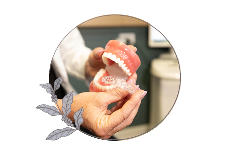close up of doctor demonstrating Invisalign patient on hoe Invisalign works