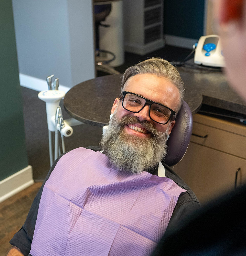 Dental patient smiling brightly and prep and ready for their dental treatment